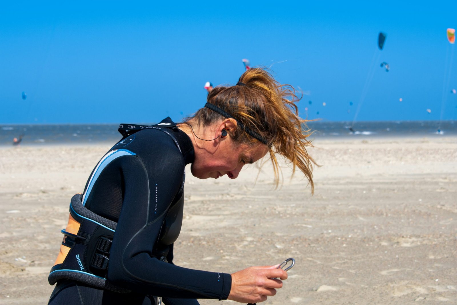 Surfer checking a surf forecast app on their phone at the beach