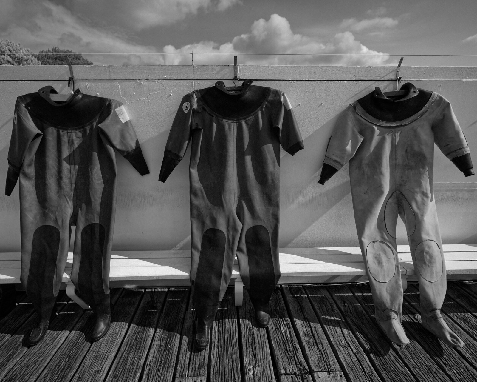 Wetsuits hanging to dry after a cold water surfing session