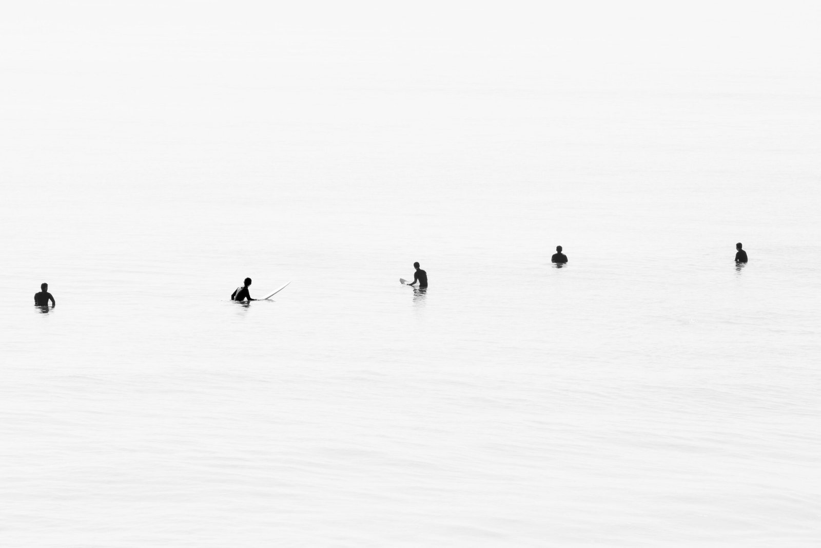 Surfers practicing surf etiquette while waiting their turn in a crowded lineup