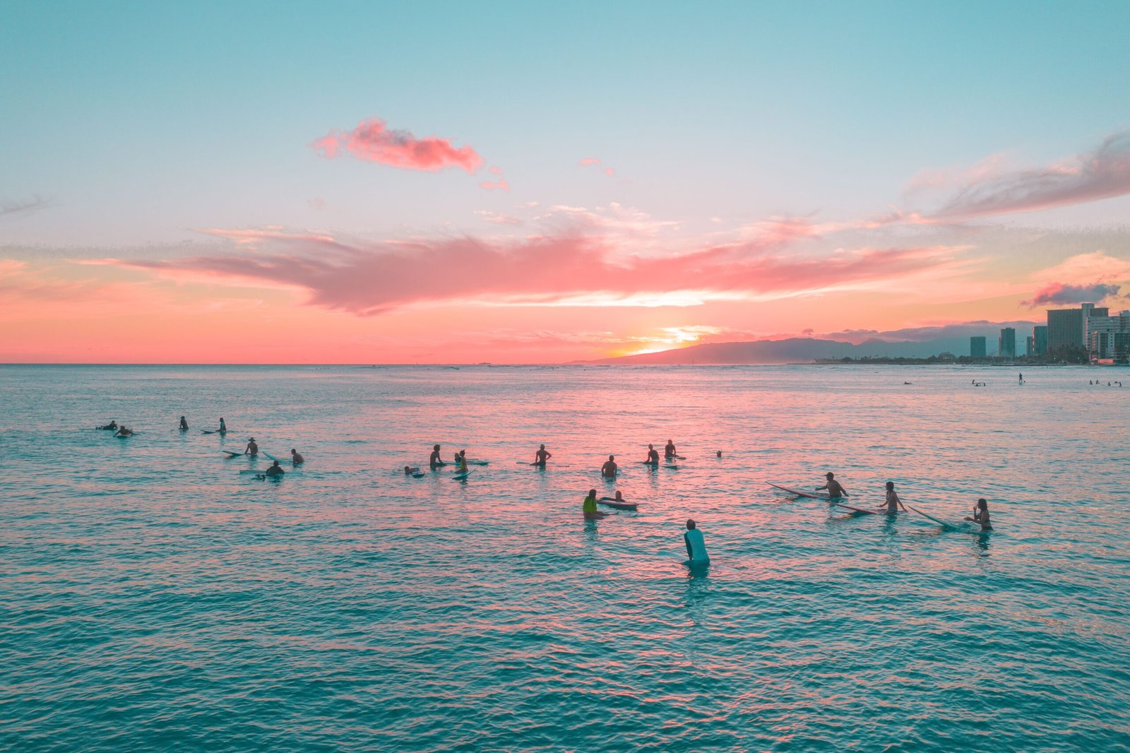 Surfers enjoying a respectful sunset session in the ocean