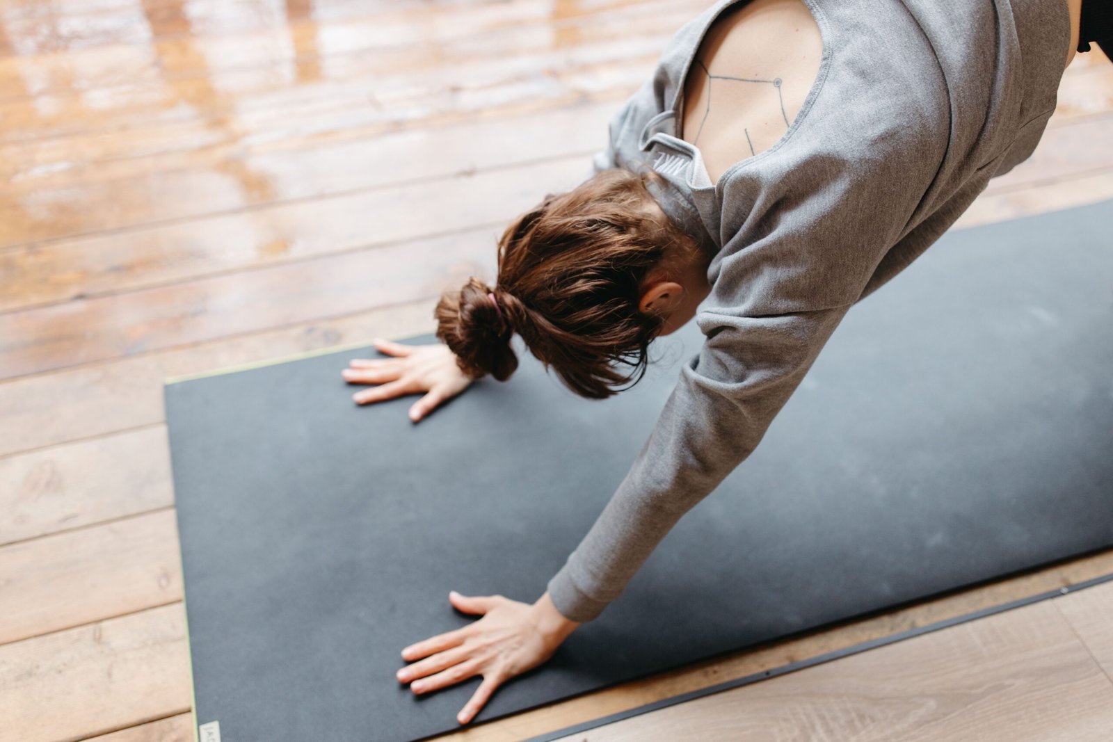 Woman practicing Downward-Facing Dog yoga pose