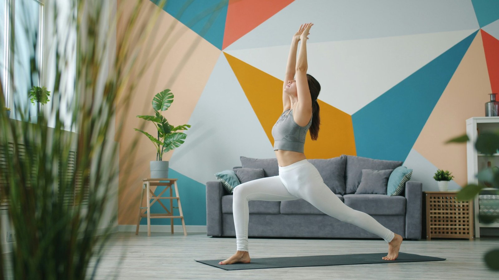 Woman practicing a home yoga routine for beginners in a bright living room